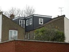 a brick building with two story windows on top