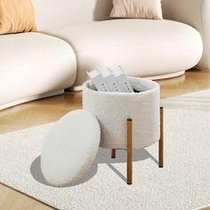 a white couch sitting next to a table on top of a wooden floor