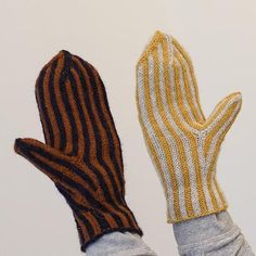 a pair of mittens sitting next to each other