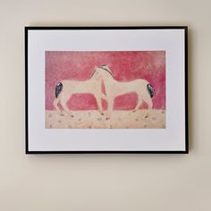 two horses standing next to each other in front of a pink sky with birds on it