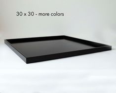 a large black tray sitting on top of a white table