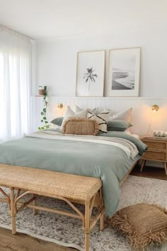 a bedroom with a bed, dresser and two framed pictures on the wall above it