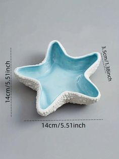 a blue star shaped bowl sitting on top of a table