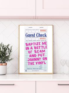 there is a poster on the counter in the kitchen that says guest check good vibes or get out