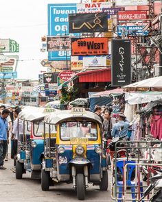 an auto rickshaw driving down a busy street