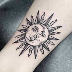 a sun and moon tattoo on the arm