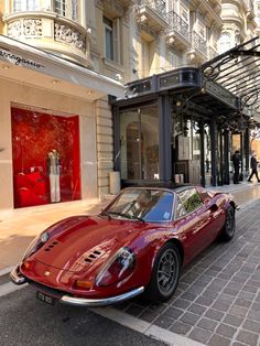 a red sports car parked in front of a store