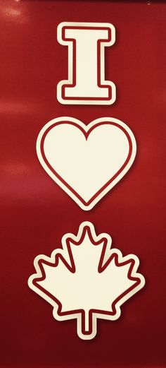 i love canada stickers on the side of a red truck with maple leaves and a heart