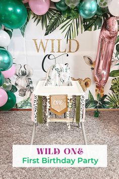 a wild one first birthday party with balloons and decorations