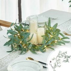 the table is set with candles and greenery