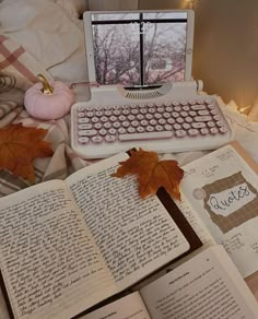 an open book sitting on top of a bed next to a computer keyboard and mouse