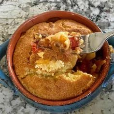 a close up of a cake in a bowl with a spoon sticking out of it