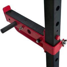 a close up of a red and black rack with two screws on each side