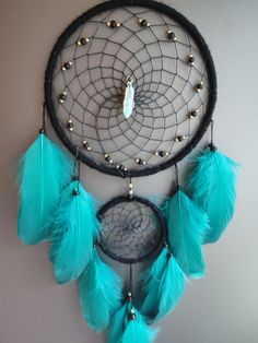 a black and blue dream catcher hanging on the wall