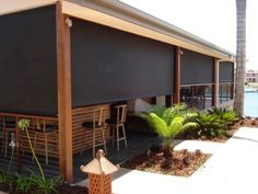 an awning on the side of a building next to a fire hydrant and palm trees