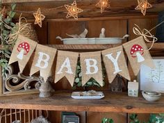 a baby banner is hanging on a shelf in a room with other items and decorations