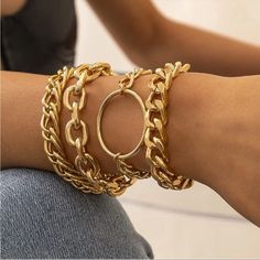 a close up of a person wearing gold bracelets