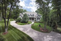 a large house surrounded by trees and grass