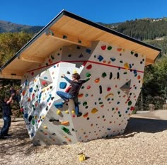 a man climbing up the side of a rock wall