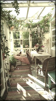 the sun shines in through an enclosed patio area with wicker chairs and tables