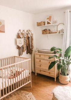 a baby's room with a crib, dresser and bed in the corner