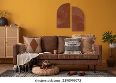 a living room with yellow walls and brown furniture in the corner, including a couch