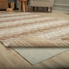 a large area rug on the floor in a living room