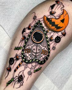 a halloween themed tattoo on the leg