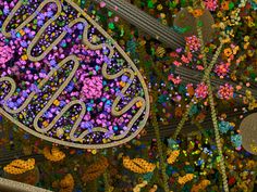 an intricately decorated wall with the word eid written in arabic and surrounded by colorful flowers