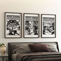 three framed comics hang on the wall above a bed