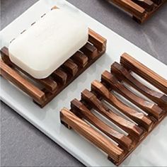 two soap dispensers sitting on top of a white tray next to each other