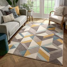 a living room with a couch, chair and rug