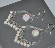 "White Opal Earrings Sterling Silver, Wedding Earrings, Bridal Bohemian Opal Jewelry Treat yourself or your loved one a perfect gift. Opal earrings are long, sparkling, and light! They will bring a perfect touch of flair and splash of magnificent colors to your special occasion dress. Opal is an ideal gift as the birthstone of October. These sparkling chandelier earrings are made from: - Sterling silver ear wires - Rhodium plated connectors - 10mm lab created opal cabochons set in sterling silve White Opal Earrings, Bridal Earrings Chandelier, Long Chandelier, Earrings Opal, Lapis Earrings, Earrings Chandelier, Sterling Silver Wedding Rings, Jewelry Earring, Opal Bracelet