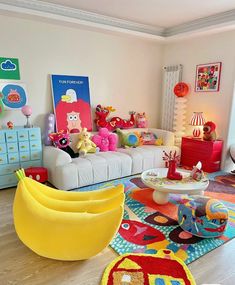 a living room filled with lots of furniture and decor on top of a hard wood floor