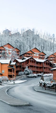 an image of a ski lodge in the mountains with snow on the ground and trees