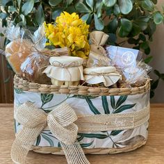 a basket filled with treats and flowers on top of a table