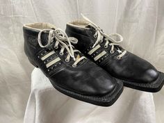 a pair of black shoes with white laces