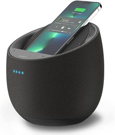 an electronic device is charging in the shape of a speaker with its dock attached to it