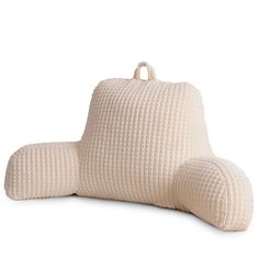 a white pillow that is shaped like an elephant's tail and has two pillows on it