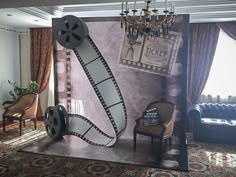 a movie themed living room with chandelier and chairs