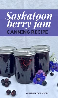 three mason jars filled with berries and blueberries on top of a white tablecloth