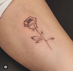 a small rose tattoo on the thigh