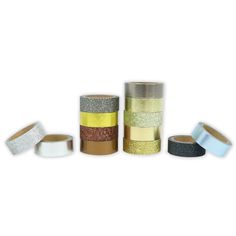 several rolls of glitter tape are lined up in different colors and sizes on a white background