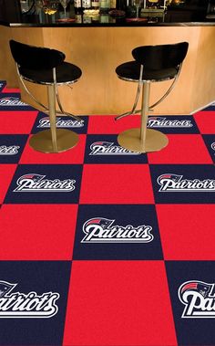 two black chairs sitting on top of a red and blue checkered floor