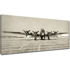 an old black and white photo of two airplanes on the runway