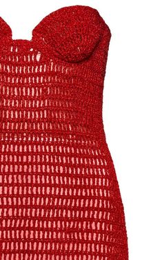 a red knitted dress with an open back and large bow at the neckline