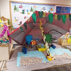 a child's play area with an umbrella and toys