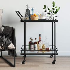 a bar cart with drinks and liquors on it