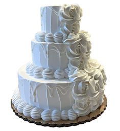 a three tiered white wedding cake with flowers on top