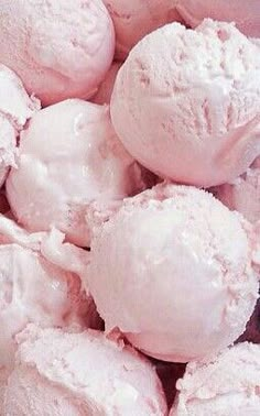 a bowl filled with pink ice cream on top of a table